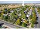 Aerial view of neighborhood with a community playground, golf course, and mountain views at 3674 Dexter St, Denver, CO 80207
