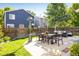 Spacious backyard with a patio set, manicured lawn, and a privacy fence at 3674 Dexter St, Denver, CO 80207