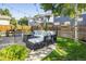 A cozy backyard patio has a fire pit and comfortable seating with string lights strung above at 3674 Dexter St, Denver, CO 80207