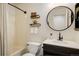 Clean bathroom featuring a shower-tub combo with a modern vanity and stylish decor at 3674 Dexter St, Denver, CO 80207