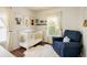 Cozy Bedroom with a crib, blue chair, plush rug, and natural light from the window at 3674 Dexter St, Denver, CO 80207