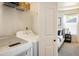 Bright laundry room featuring a washer, dryer, and shelf with access to main bedroom at 3674 Dexter St, Denver, CO 80207