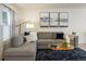 Comfortable living room with a plush sectional sofa, decorative pillows, and elegant artwork at 3674 Dexter St, Denver, CO 80207