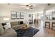 Open-concept living room featuring wood floors, comfortable seating, and abundant natural light at 3674 Dexter St, Denver, CO 80207