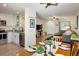 Open-concept living area featuring a modern kitchen, dining area, and cozy living space at 3674 Dexter St, Denver, CO 80207