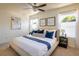 Bright primary bedroom with a ceiling fan, two sunny windows, and modern decor at 3674 Dexter St, Denver, CO 80207