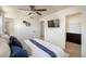 Bright bedroom features a ceiling fan, TV, and access to a walk-in closet and bathroom at 3674 Dexter St, Denver, CO 80207