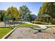The community playground has swings, a slide, and a picnic area under a shaded gazebo at 3674 Dexter St, Denver, CO 80207