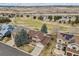Aerial view of property backing to green space, with mature landscaping and golf course nearby at 401 W Prestwick Way, Castle Rock, CO 80104