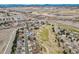 An aerial view shows homes bordering a putting green in the community, with views of the mountains at 401 W Prestwick Way, Castle Rock, CO 80104