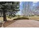 A vast backyard view showcases a putting green, manicured shrubbery, and mature trees creating a serene outdoor space at 401 W Prestwick Way, Castle Rock, CO 80104