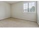 Small bedroom featuring neutral walls, carpet and natural light from a window at 401 W Prestwick Way, Castle Rock, CO 80104