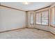 Bedroom featuring a bay window, neutral carpet, and wood trim at 401 W Prestwick Way, Castle Rock, CO 80104