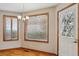 Dining room with a hardwood floor, a chandelier, and light streaming through the window at 401 W Prestwick Way, Castle Rock, CO 80104