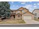 Charming two-story home with a three-car tandem garage and mature landscaping at 401 W Prestwick Way, Castle Rock, CO 80104