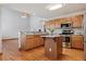 This gourmet kitchen has wood cabinets, stainless appliances, a center island, and wood floors at 401 W Prestwick Way, Castle Rock, CO 80104