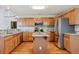 This gourmet kitchen has wood cabinets, stainless appliances, a center island, granite counters, and wood floors at 401 W Prestwick Way, Castle Rock, CO 80104