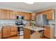 Gourmet kitchen with stainless steel appliances, granite counters, oak cabinets, and an island with a granite top at 401 W Prestwick Way, Castle Rock, CO 80104