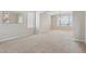 Bright living room with neutral carpet, natural light, and a view of the entry hall with staircase at 401 W Prestwick Way, Castle Rock, CO 80104