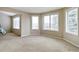 Bright living room featuring neutral walls, carpet and natural light from many windows at 401 W Prestwick Way, Castle Rock, CO 80104