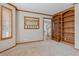 Home office with built-in bookshelves and a neutral color palette at 401 W Prestwick Way, Castle Rock, CO 80104