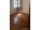 Bedroom featuring hardwood floors and a window with natural light at 160 Utica St, Denver, CO 80219