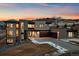 Modern home with a three-car garage, beautiful stone accents, and professional landscaping at sunset at 5263 Creation Rock Trl, Morrison, CO 80465