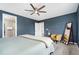 Serene primary bedroom with a ceiling fan, chair, and leaning mirror at 18077 E 99Th Ave, Commerce City, CO 80022