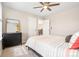 Comfortable bedroom featuring neutral decor, carpet flooring, and a ceiling fan at 18077 E 99Th Ave, Commerce City, CO 80022
