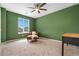 Cozy bedroom with an olive green accent wall, carpet, and an inviting accent chair at 18077 E 99Th Ave, Commerce City, CO 80022