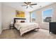 Bright bedroom with a ceiling fan, carpet flooring, and plenty of natural light at 18077 E 99Th Ave, Commerce City, CO 80022