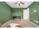 Bright bedroom featuring modern ceiling fan, green walls, and neutral carpet at 18077 E 99Th Ave, Commerce City, CO 80022