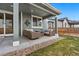 Relaxing covered patio with comfortable seating, perfect for enjoying the outdoors in style at 18077 E 99Th Ave, Commerce City, CO 80022