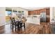Bright dining area with wood floors, a stylish table set, and sliding glass doors to outside at 18077 E 99Th Ave, Commerce City, CO 80022