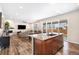 Open-concept kitchen island with granite counters, and a spacious living area with a fireplace at 18077 E 99Th Ave, Commerce City, CO 80022