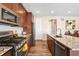 Modern kitchen boasts stainless steel appliances, granite countertops and wood flooring at 18077 E 99Th Ave, Commerce City, CO 80022