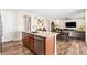 Open-concept kitchen featuring a granite island and stainless steel dishwasher at 18077 E 99Th Ave, Commerce City, CO 80022