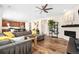 Spacious living room with modern sectional, fireplace, and open view to the kitchen at 18077 E 99Th Ave, Commerce City, CO 80022