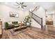 Inviting living room features a plush green sofa, modern ceiling fan, and stylish decor at 18077 E 99Th Ave, Commerce City, CO 80022