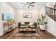 Stylish living room with modern decor, hardwood floors, and ample natural light at 18077 E 99Th Ave, Commerce City, CO 80022