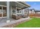 Cozy covered patio with comfortable seating and stylish decor for outdoor relaxation at 18077 E 99Th Ave, Commerce City, CO 80022