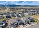 An aerial perspective highlights a neighborhood's layout, showcasing modern homes, streets, and scenic mountain backdrop at 8517 Eckley St, Littleton, CO 80125