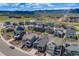 Stunning aerial view of a neighborhood with mountain views, featuring modern homes with well-maintained lawns at 8517 Eckley St, Littleton, CO 80125