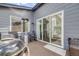 A lovely covered back deck with sliding glass doors, grill, heater, and comfortable rocking chairs at 8517 Eckley St, Littleton, CO 80125