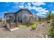 A low maintenance backyard with a shade sail, a play area, and a covered patio area is ready for fun at 8517 Eckley St, Littleton, CO 80125
