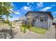 A low maintenance backyard with a playset, covered patio, rock landscaping, and plenty of space to enjoy at 8517 Eckley St, Littleton, CO 80125