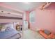 Pink bedroom featuring a bunk bed, bean bag chair, and a plush pony at 8517 Eckley St, Littleton, CO 80125