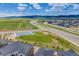 Scenic aerial view showcases a community park with a basketball court, roads, and neighborhood homes against a mountain backdrop at 8517 Eckley St, Littleton, CO 80125
