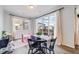 Bright dining area with large windows, a dark table, and view of the neighborhood at 8517 Eckley St, Littleton, CO 80125