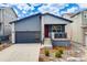 Charming single-Gathering home boasts a modern design, landscaping, and a welcoming red front door at 8517 Eckley St, Littleton, CO 80125